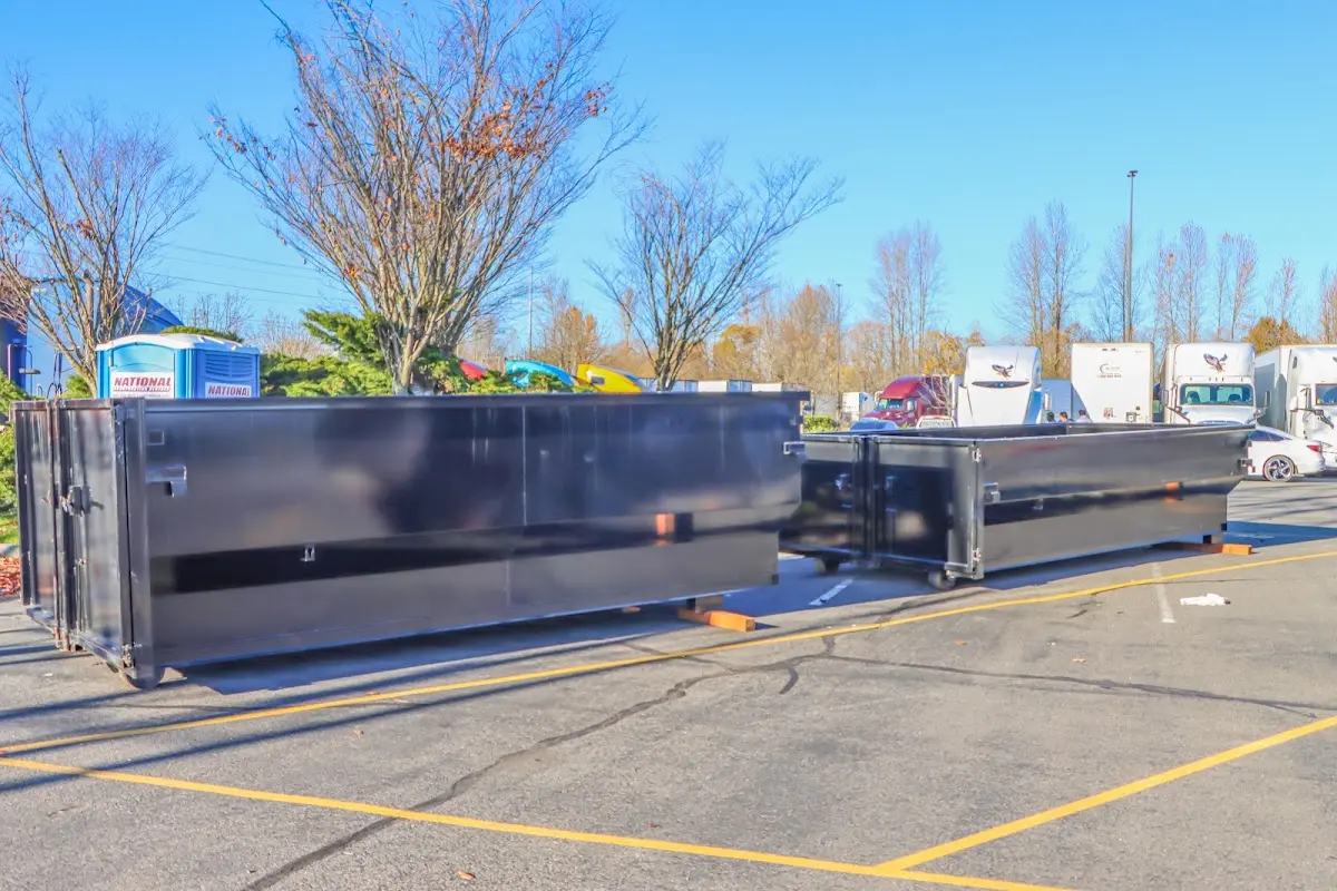 Professional dumpster rental service with roll-off container on residential driveway in Coraopolis